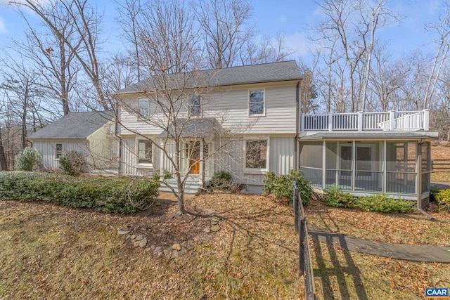 view of front of property featuring a balcony and a sunroom