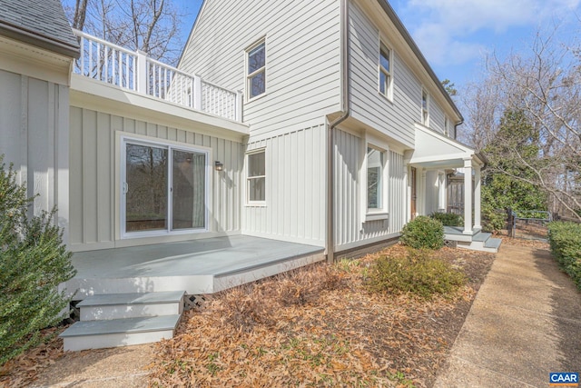 view of home's exterior with board and batten siding and a balcony