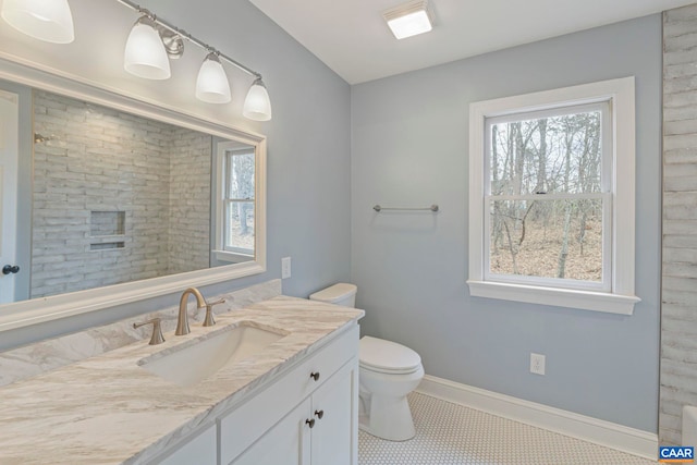 full bathroom featuring toilet, vanity, baseboards, a shower, and tile patterned floors