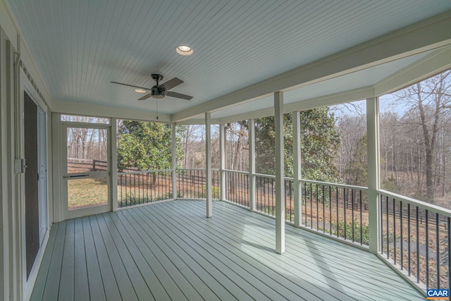 unfurnished sunroom with ceiling fan