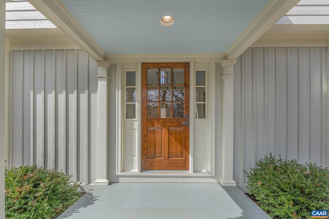 view of exterior entry with board and batten siding