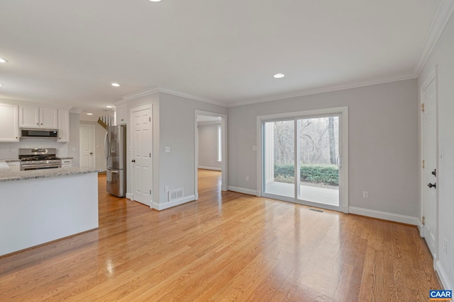 unfurnished living room featuring light wood-type flooring, visible vents, and crown molding