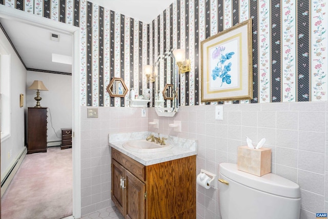 bathroom with vanity, a baseboard heating unit, tile walls, toilet, and baseboard heating