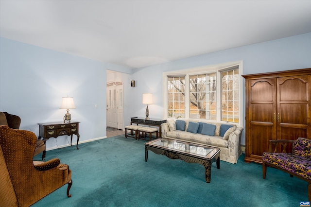 carpeted living area featuring baseboards