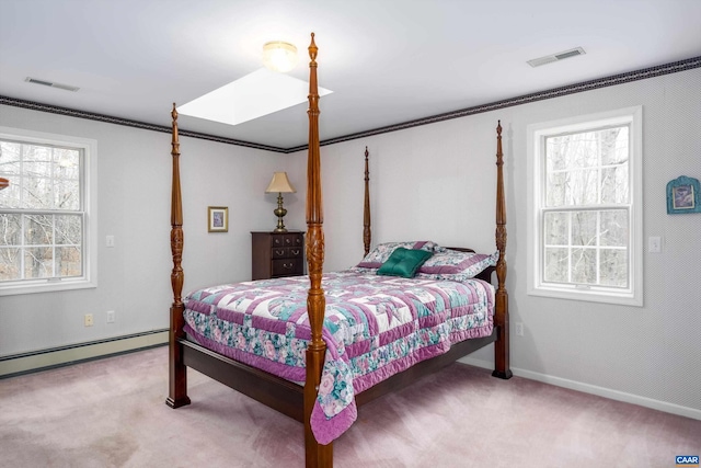 bedroom with a baseboard radiator, carpet floors, visible vents, and a skylight