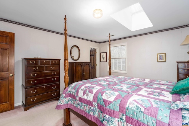 bedroom featuring crown molding, a skylight, and light colored carpet