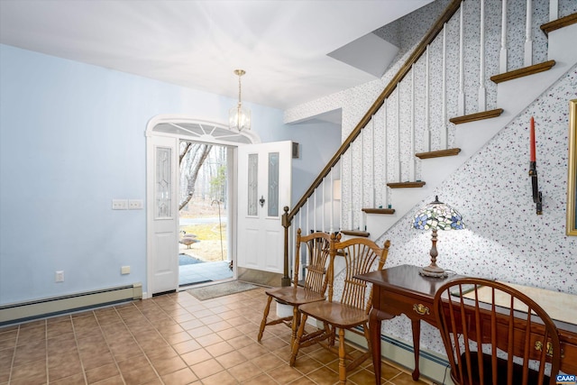 tiled foyer entrance with a baseboard heating unit, stairs, wallpapered walls, and a chandelier