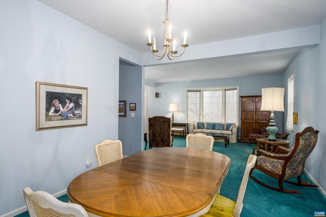 dining room featuring a notable chandelier, baseboards, and carpet floors