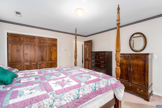 bedroom with baseboards, visible vents, ornamental molding, a closet, and light carpet