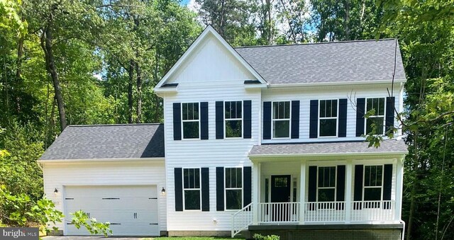 view of front of property featuring a garage and a porch