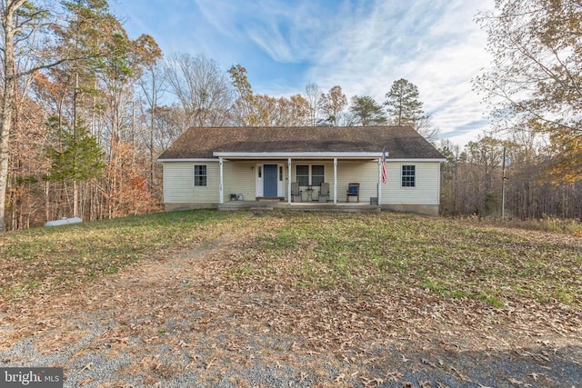 ranch-style house featuring a porch and a front yard