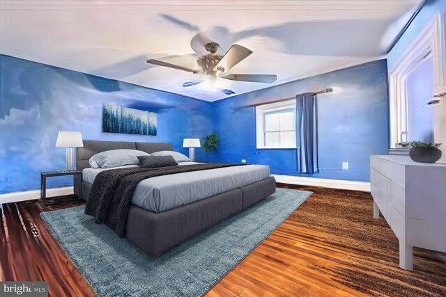 bedroom with dark wood-style floors, ceiling fan, and baseboards