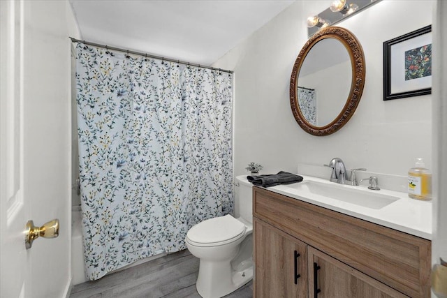 bathroom featuring vanity, hardwood / wood-style flooring, and toilet