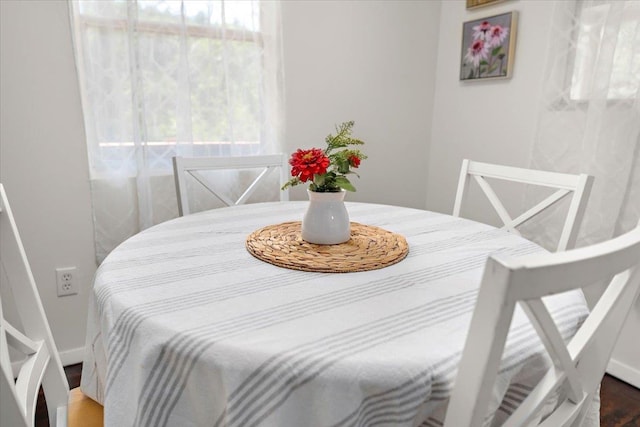 dining space with wood-type flooring