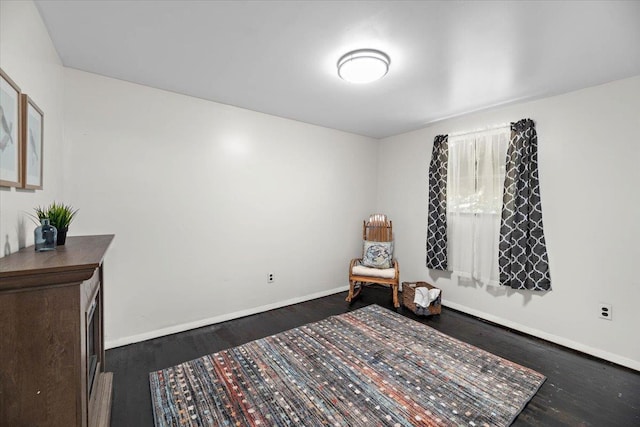 sitting room featuring dark wood-type flooring