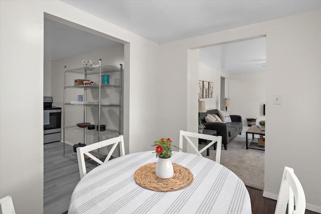 dining space with dark wood-type flooring