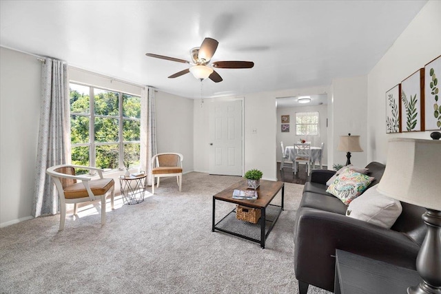 carpeted living room featuring ceiling fan