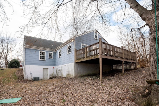 rear view of property featuring a wooden deck and central air condition unit