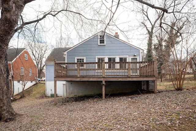 back of property featuring a chimney and a deck