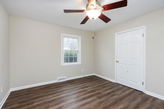 unfurnished room featuring baseboards, visible vents, ceiling fan, and dark wood-type flooring