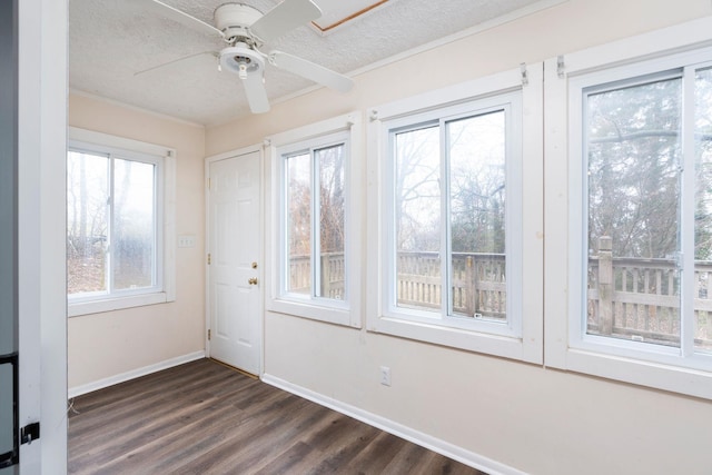 unfurnished sunroom featuring ceiling fan