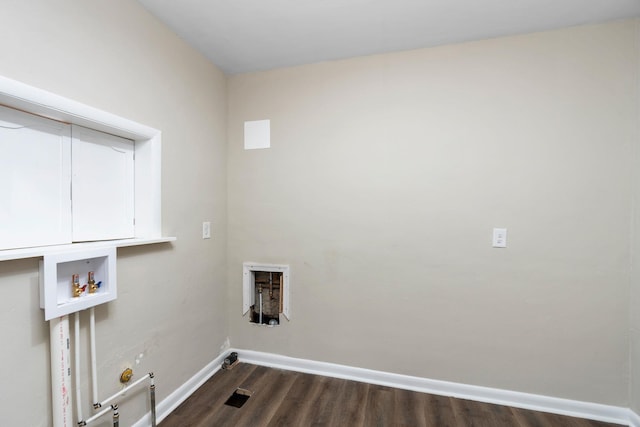 clothes washing area featuring dark wood-type flooring, hookup for a gas dryer, hookup for a washing machine, and baseboards