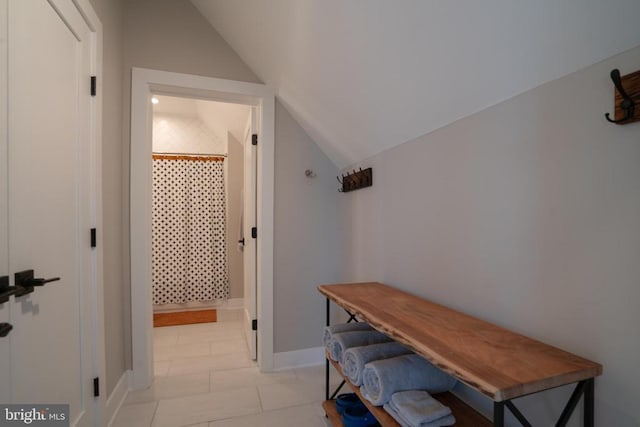 hallway featuring vaulted ceiling