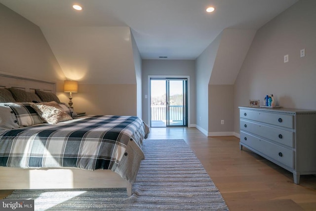 bedroom featuring access to exterior and light hardwood / wood-style floors