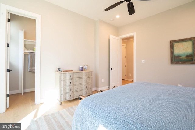 bedroom with ceiling fan and light hardwood / wood-style floors