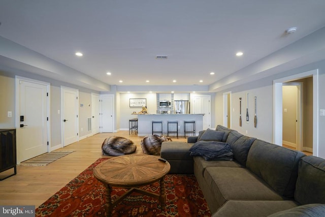 living room with light hardwood / wood-style flooring