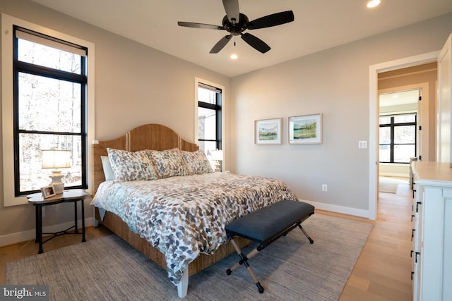 bedroom with ceiling fan and light hardwood / wood-style floors