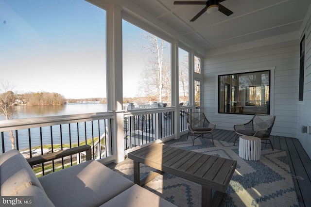 sunroom / solarium featuring a water view and ceiling fan