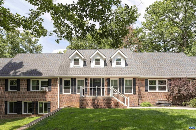 cape cod house with cooling unit and a front yard