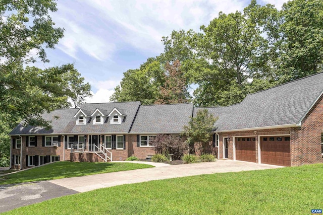 new england style home featuring a garage, a front yard, and covered porch