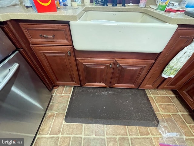 details featuring light countertops, a sink, and range