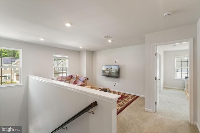 corridor featuring light colored carpet