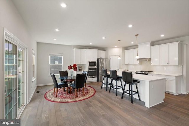 dining room with hardwood / wood-style flooring and a wealth of natural light