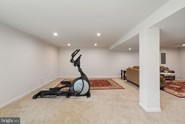 exercise room featuring light carpet