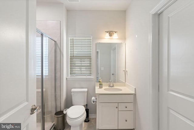 bathroom with vanity, toilet, and walk in shower