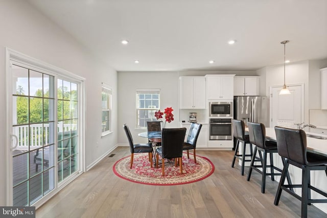 dining area with light wood-type flooring