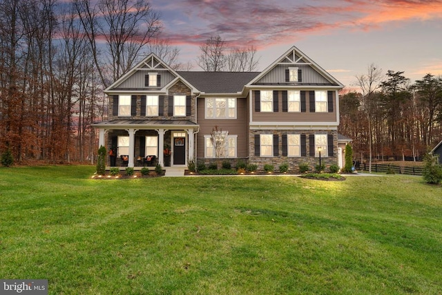 craftsman house with a lawn and a porch