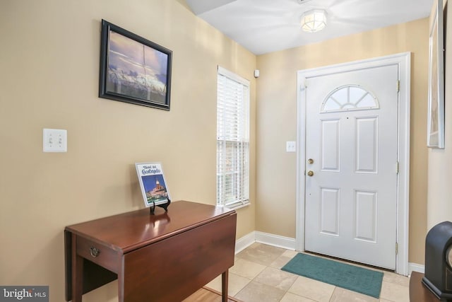 entryway featuring light tile patterned floors and baseboards