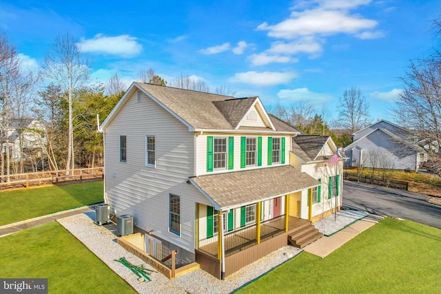 back of house with central AC unit, a lawn, aphalt driveway, fence, and a porch