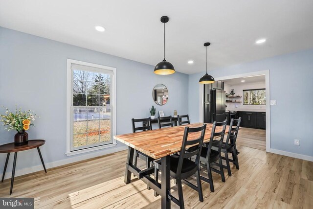 dining space with light wood-style floors, baseboards, and recessed lighting