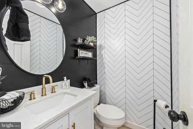 bathroom featuring toilet and vanity