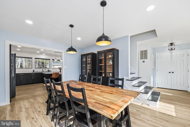 dining space featuring light wood finished floors, visible vents, stairway, and recessed lighting