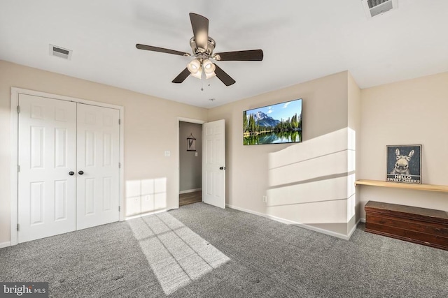 unfurnished bedroom featuring baseboards, a closet, visible vents, and carpet flooring