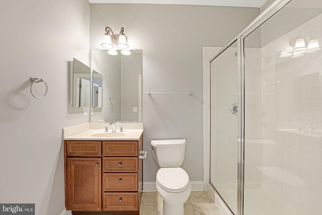 bathroom with tile patterned floors, a stall shower, toilet, and vanity