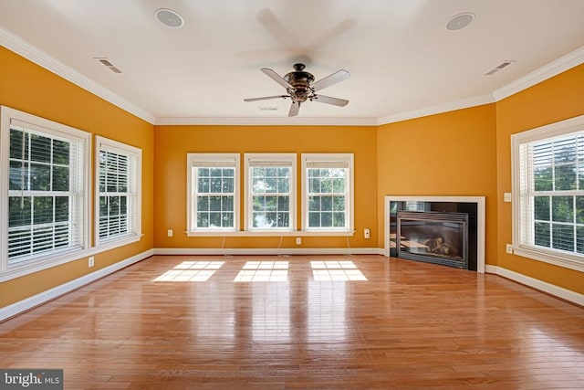 unfurnished living room featuring visible vents, hardwood / wood-style flooring, a ceiling fan, and ornamental molding