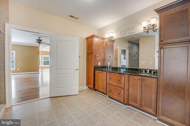 bathroom featuring ceiling fan, tile patterned floors, visible vents, and a sink